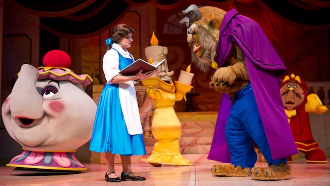 Belle reads to the Beast in a scene from Beauty and the Beast—Live on Stage at Disney's Hollywood Studios