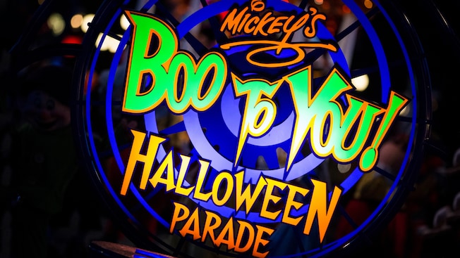 A brightly lit sign reads: ‘Mickey’s Boo To You! Halloween Parade’