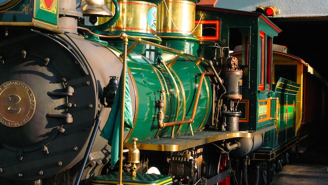 A shiny green antique steam locomotive