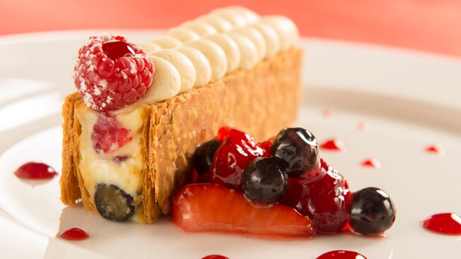 A dessert plate with Red Berries Napoleon with light lemon cream and strawberry sorbet