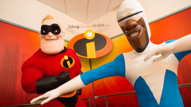 Mr. Incredible and Frozone stand next to each other in Animation Courtyard