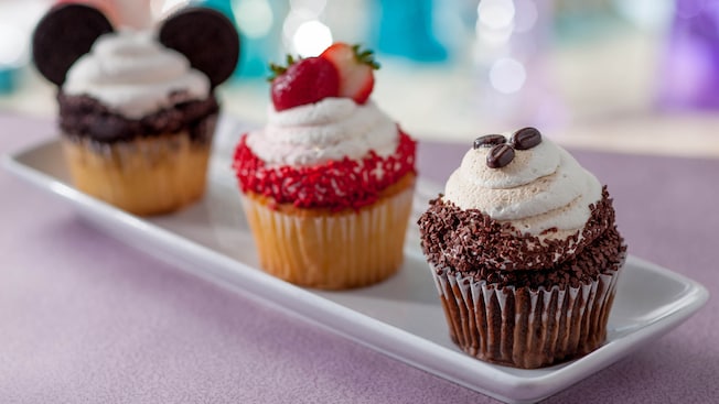 3 cupcakes on a tray, one with Mickey ears