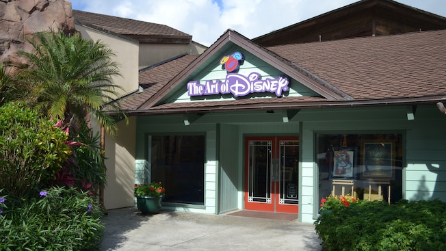 The Craftsman-style exterior of the Art of Disney store with the Art of Disney sign above the door