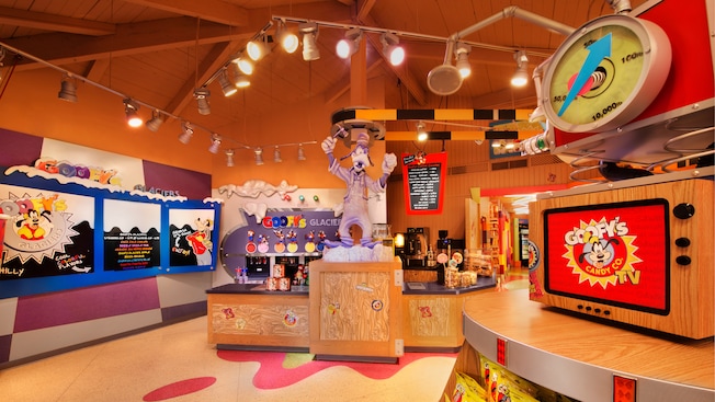 Goofy surrounded by sweet treats at Goofy's Candy Co. at Downtown Disney Marketplace