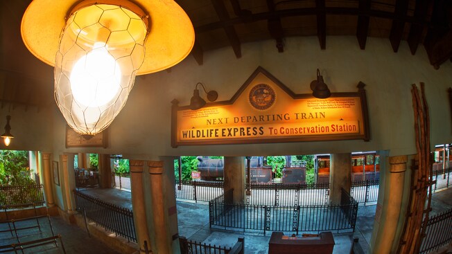 Inside Harambe station with a sign announcing the Wildlife Express to Conservation Station