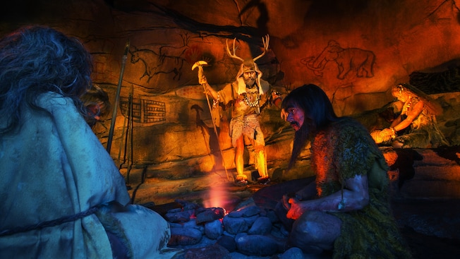 A scene of cavemen and cave paintings in the Spaceship Earth attraction