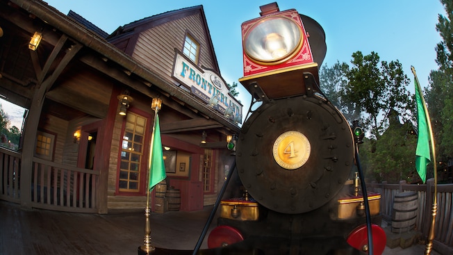 The front of a steam locomotive at the Frontierland Railroad Station at dawn