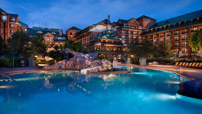 Nighttime view of Silver Creek Springs pool featuring a waterslide and a hot tub