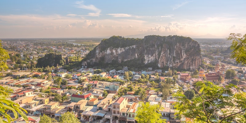 The city of Hoi An, Vietnam spread out from the base of the Marble Mountains
