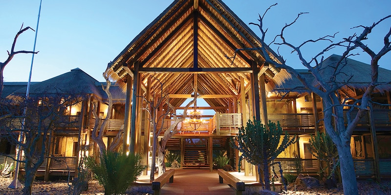 The impressive arched entrance to the Kapama River Lodge at twilight