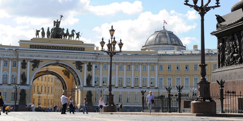 A palatial building, with statues adorning the roof