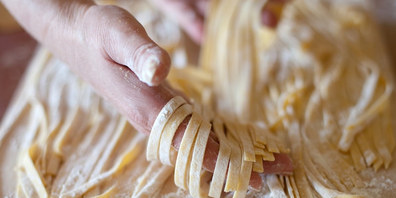 A woman makes pasta from scratch
