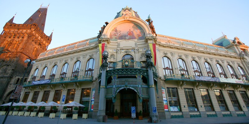 A grand old European building with an arched entry