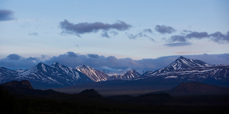 A scenic mountain range at twilight A scenic mountain range at twilight