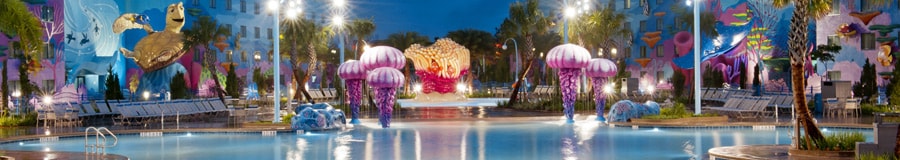 A nighttime view of Finding Nemo pool at Disney's Art of Animation Resort with colorful play areas