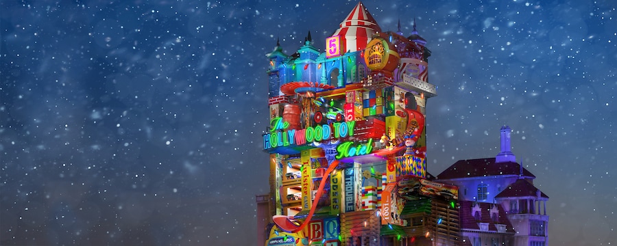 The Hollywood Toy Hotel lit up with lights near trees and falling snow