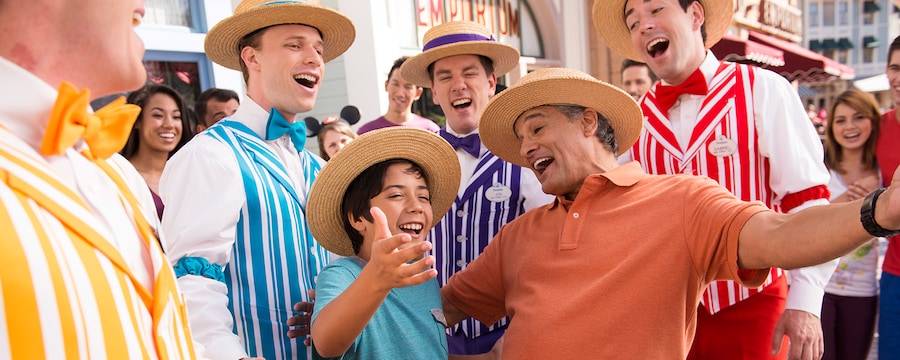 A father and son sing along with the Dapper Dans while on their Disney vacation at Disneyland Resort